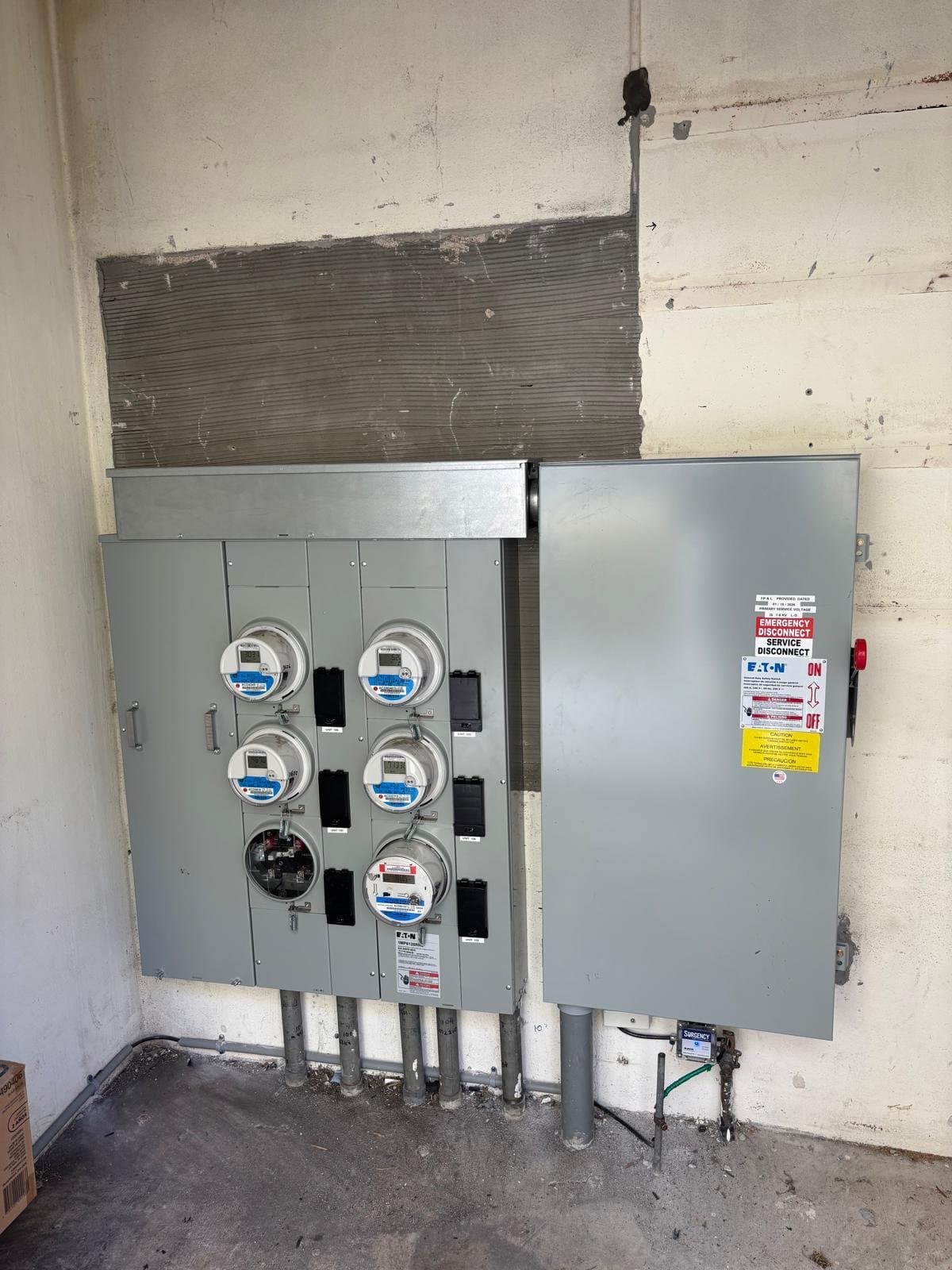 A rebuilt multi-meter service with a new Eaton emergency disconnect, installed by Ghost Crown Electric