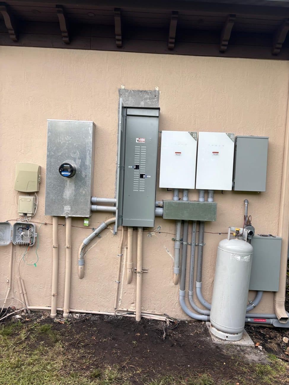 A completed residential electrical service with meter, main panel, disconnects, and battery backup